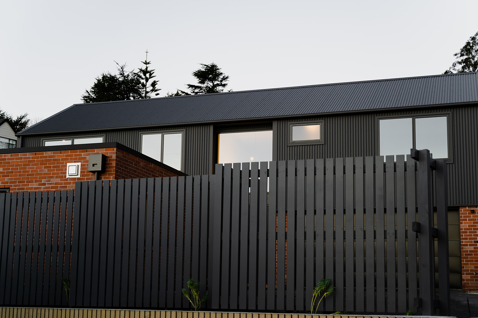 Huntsbury House: Modern Home with Clay Brick and Deep Grey Metal Facade