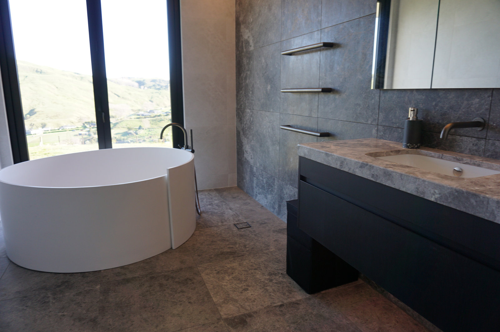 Home Bathroom Tile Renovation with Round Bathtub as Focal Point