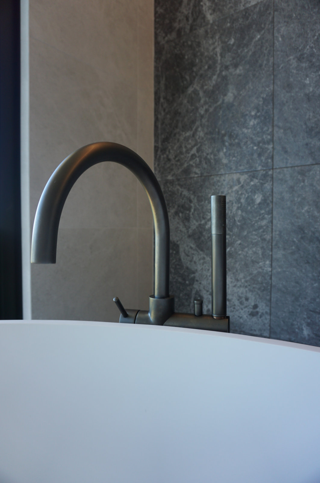 Home Bathroom Tile Renovation with Round Bathtub as Focal Point