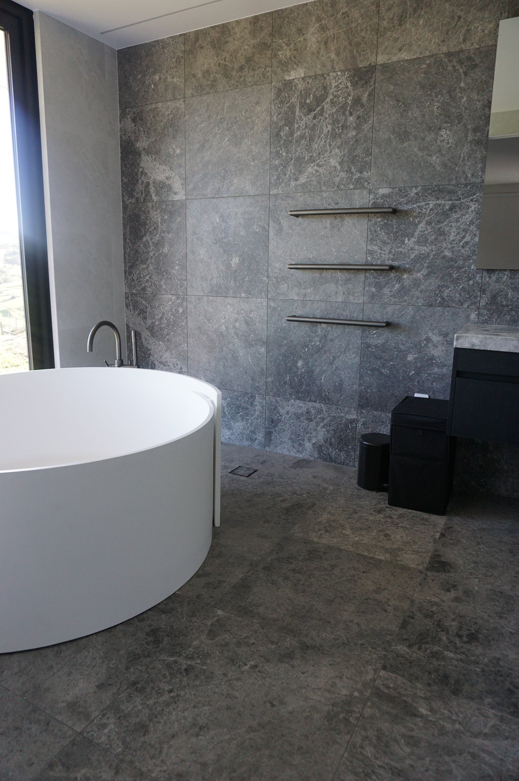 Home Bathroom Tile Renovation with Round Bathtub as Focal Point