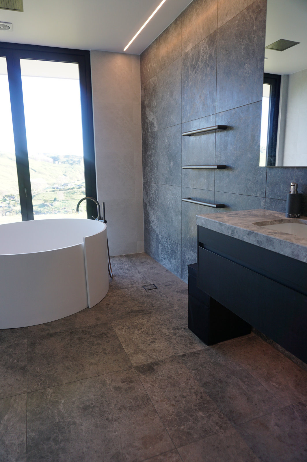 Home Bathroom Tile Renovation with Round Bathtub as Focal Point